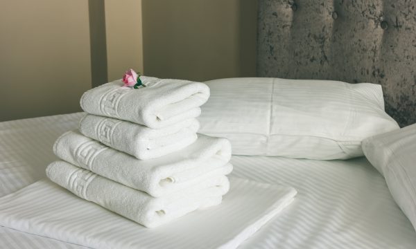 White Bed Sheets With Brown Bed In Hotel Room